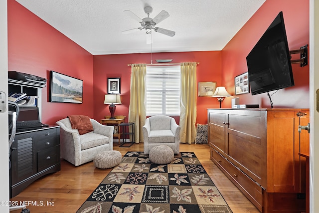 708 El Vergel Ln, Saint Augustine, FL 32080 - sitting room with light wood-style floors, a ceiling fan, and a textured ceiling