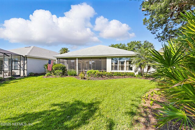 708 El Vergel Ln, Saint Augustine, FL 32080 - rear view of property featuring a lanai, a lawn, and stucco siding