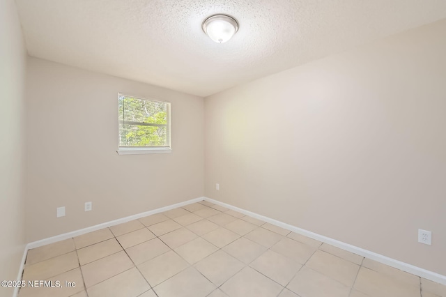 11764 Raven Dr W, Jacksonville, FL 32218 - unfurnished room featuring a textured ceiling, light tile patterned flooring, and baseboards