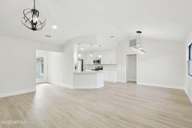 unfurnished living room with visible vents, lofted ceiling, and a chandelier