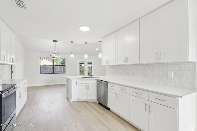 kitchen with white cabinets, stainless steel appliances, and visible vents