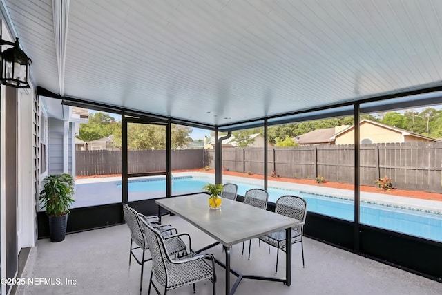 sunroom / solarium with outdoor dining area