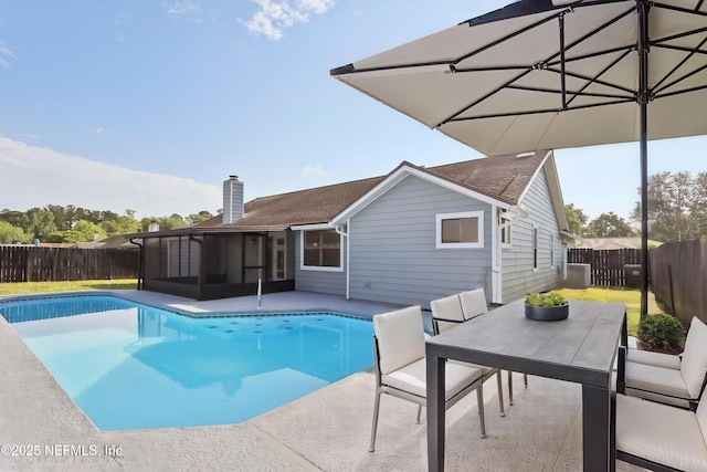 view of pool featuring a sunroom, a fenced backyard, a patio area, and a fenced in pool