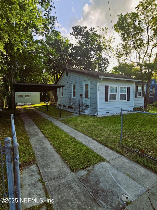 4916 Dundee Rd, Jacksonville, FL 32210 - view of front of property featuring a front yard, driveway, entry steps, and a carport
