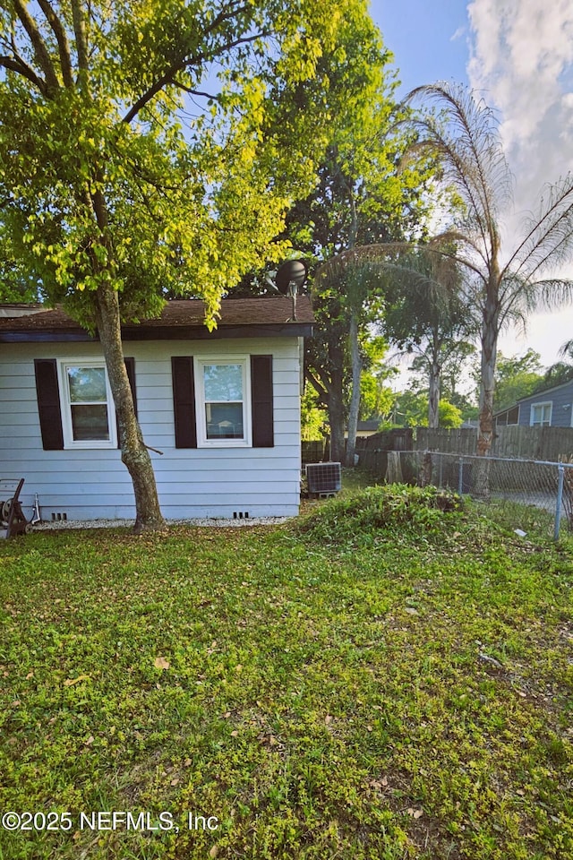 4916 Dundee Rd, Jacksonville, FL 32210 - exterior space with a yard, fence, central AC, and crawl space