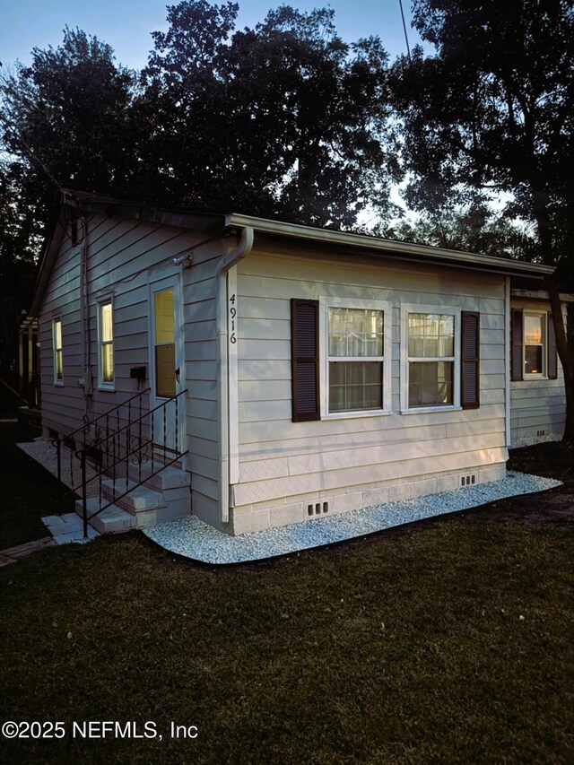 4916 Dundee Rd, Jacksonville, FL 32210 - exterior space with crawl space and a yard