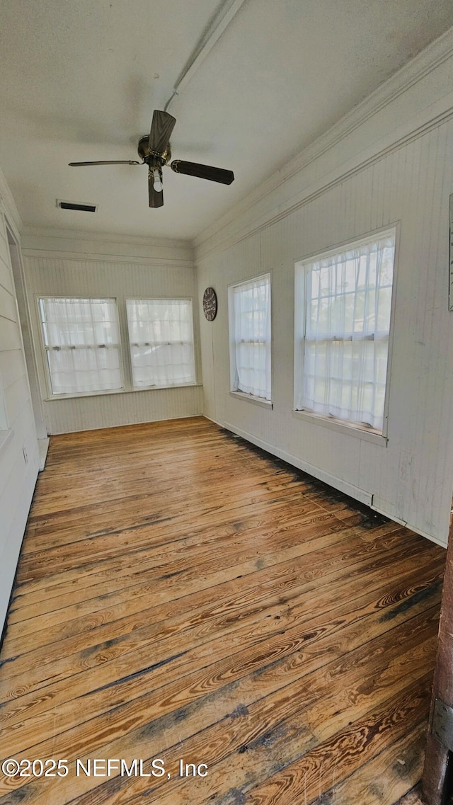 4916 Dundee Rd, Jacksonville, FL 32210 - spare room with visible vents, ornamental molding, a ceiling fan, and wood finished floors