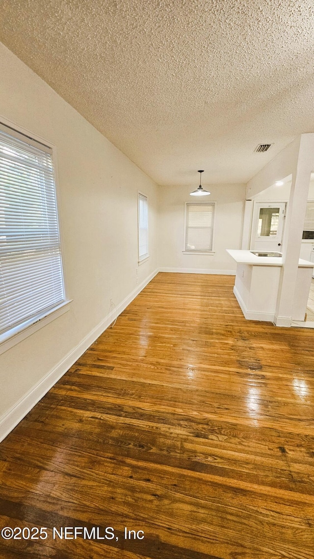 4916 Dundee Rd, Jacksonville, FL 32210 - interior space featuring visible vents, baseboards, wood finished floors, and a textured ceiling