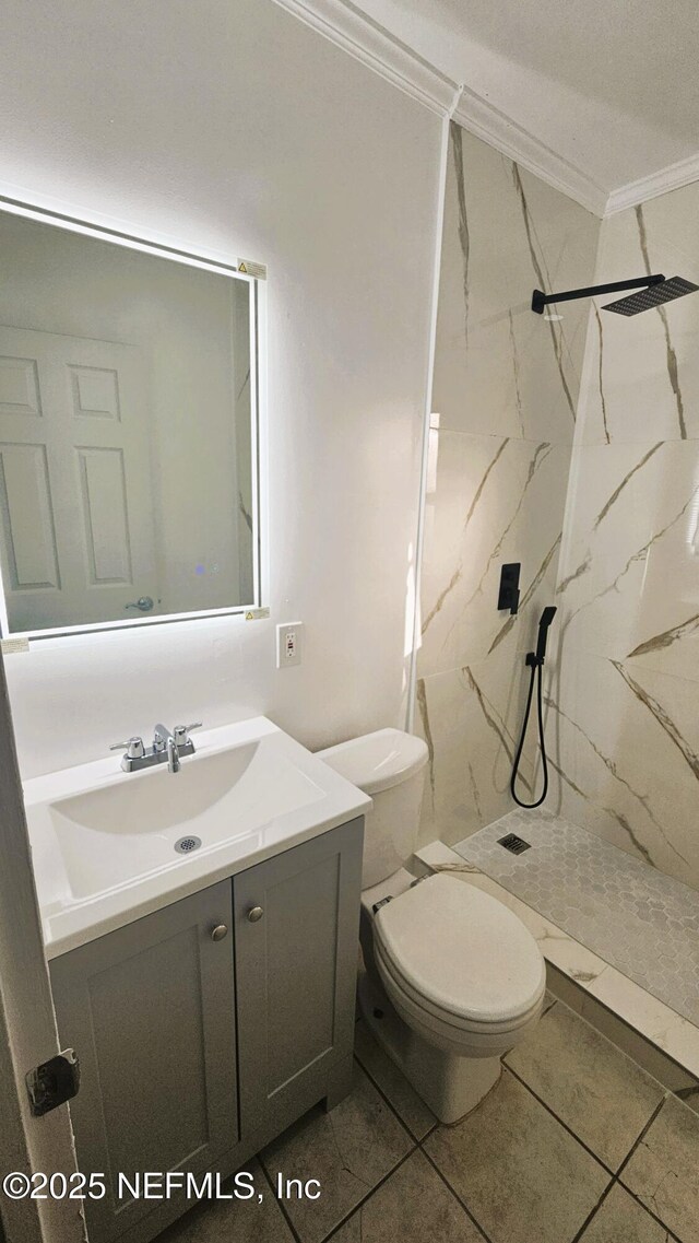 4916 Dundee Rd, Jacksonville, FL 32210 - bathroom with toilet, vanity, ornamental molding, and a marble finish shower