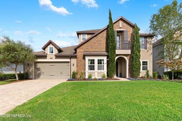 view of front facade featuring a balcony, stucco siding, decorative driveway, and stone siding