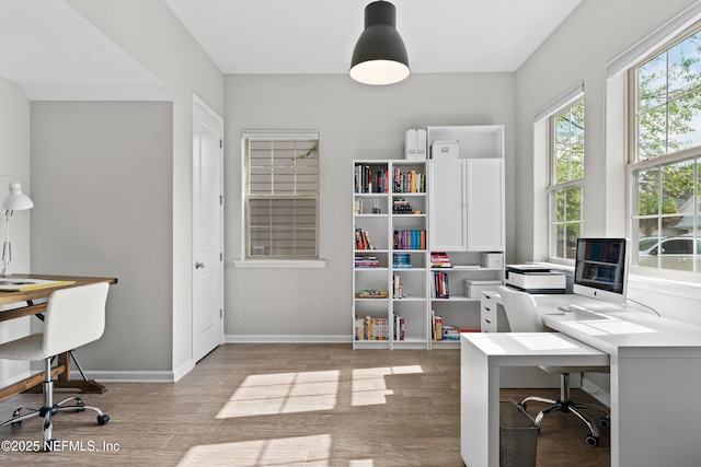 office area featuring baseboards and wood finished floors