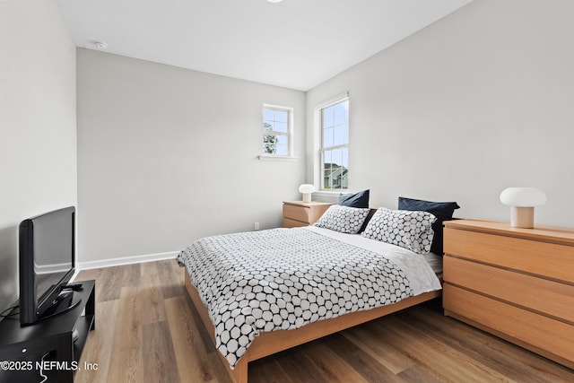 bedroom featuring baseboards and wood finished floors