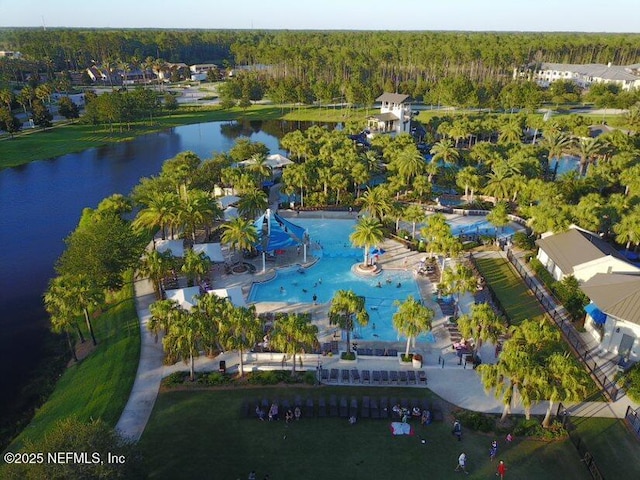 drone / aerial view with a water view and a wooded view
