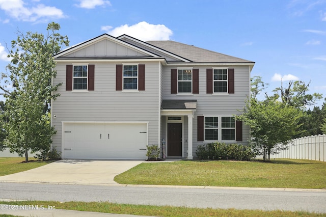 view of front of house featuring board and batten siding, a front yard, fence, an attached garage, and driveway
