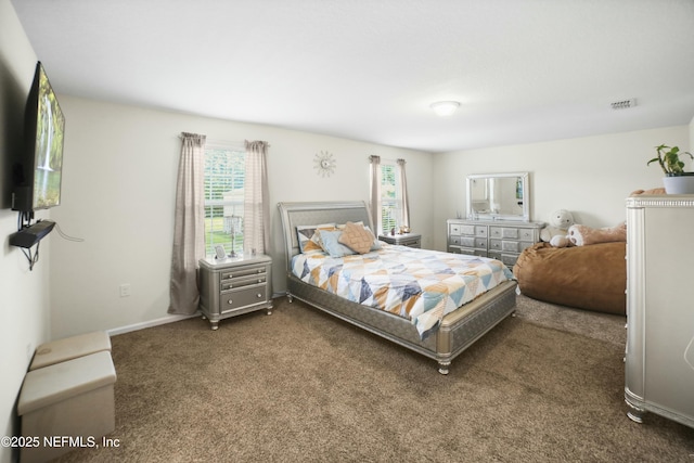 carpeted bedroom featuring baseboards, multiple windows, and visible vents