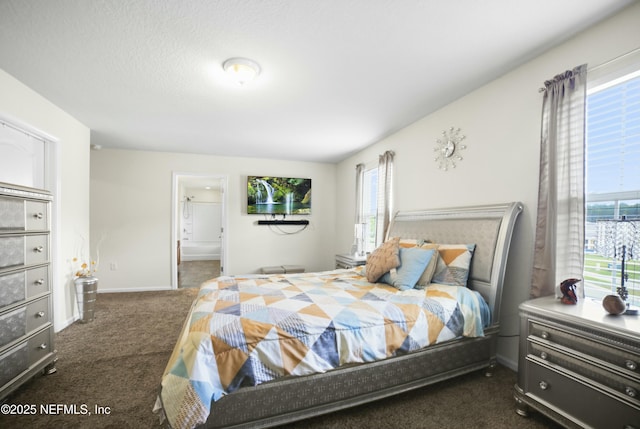 carpeted bedroom featuring ensuite bathroom and baseboards