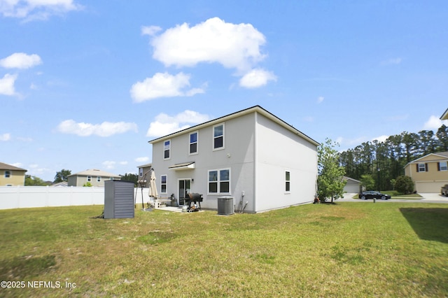 back of property with fence, a lawn, a patio area, and central air condition unit