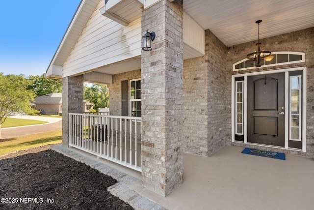 11975 Smith Pointe Ct, Jacksonville, FL 32218 - doorway to property featuring brick siding and covered porch
