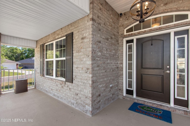 11975 Smith Pointe Ct, Jacksonville, FL 32218 - doorway to property with a porch and brick siding