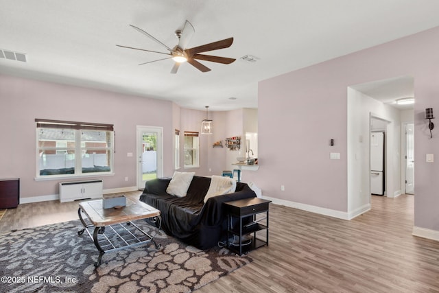 11975 Smith Pointe Ct, Jacksonville, FL 32218 - living area featuring wood finished floors, a ceiling fan, and visible vents