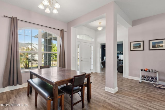11975 Smith Pointe Ct, Jacksonville, FL 32218 - dining area with a notable chandelier, baseboards, and wood finished floors