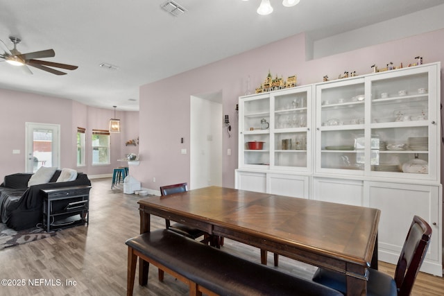 11975 Smith Pointe Ct, Jacksonville, FL 32218 - dining room with light wood finished floors, a ceiling fan, and visible vents