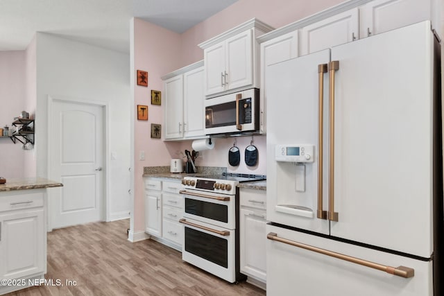 11975 Smith Pointe Ct, Jacksonville, FL 32218 - kitchen with white cabinets, light stone countertops, white appliances, and light wood finished floors