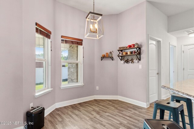 11975 Smith Pointe Ct, Jacksonville, FL 32218 - unfurnished dining area featuring light wood finished floors, visible vents, and baseboards
