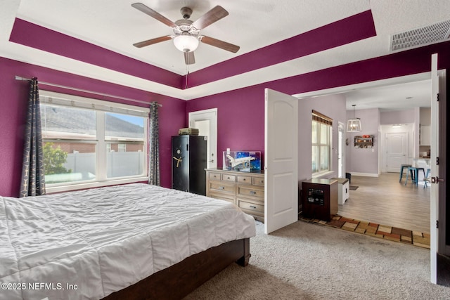 11975 Smith Pointe Ct, Jacksonville, FL 32218 - carpeted bedroom with visible vents, baseboards, a ceiling fan, and a raised ceiling