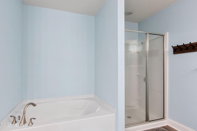 11975 Smith Pointe Ct, Jacksonville, FL 32218 - bathroom with a textured ceiling, a shower stall, and a garden tub