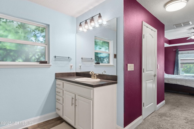 11975 Smith Pointe Ct, Jacksonville, FL 32218 - ensuite bathroom with vanity, a textured wall, ensuite bath, and visible vents