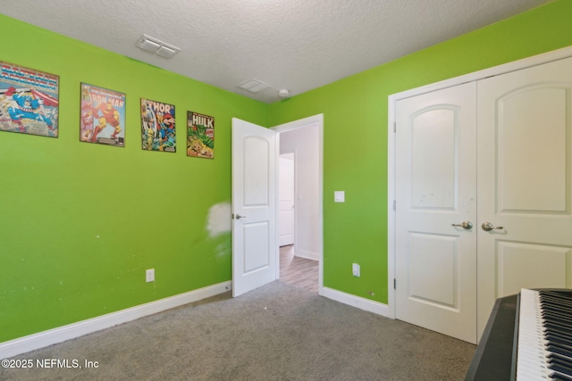 11975 Smith Pointe Ct, Jacksonville, FL 32218 - bedroom with carpet, a textured ceiling, a closet, visible vents, and baseboards
