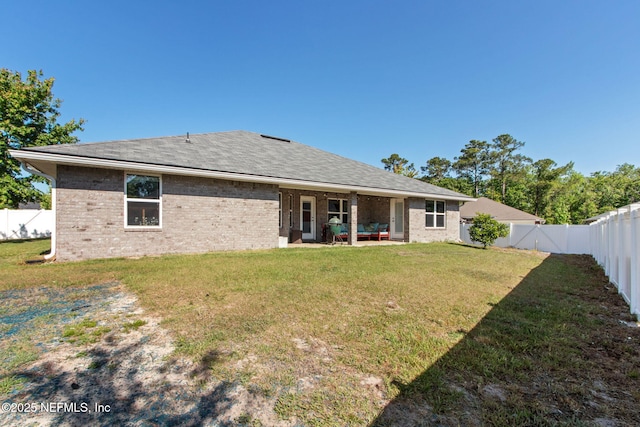 11975 Smith Pointe Ct, Jacksonville, FL 32218 - back of property featuring a patio area, brick siding, a fenced backyard, and a lawn
