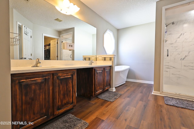 3038 Majestic Oaks Ln, Green Cove Springs, FL 32043 - bathroom with a stall shower, a soaking tub, double vanity, and a textured ceiling