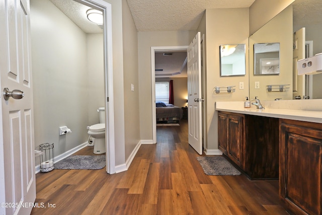 3038 Majestic Oaks Ln, Green Cove Springs, FL 32043 - ensuite bathroom featuring baseboards, a textured ceiling, connected bathroom, toilet, and wood finished floors