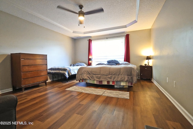 3038 Majestic Oaks Ln, Green Cove Springs, FL 32043 - bedroom featuring a tray ceiling, a textured ceiling, a ceiling fan, wood finished floors, and baseboards