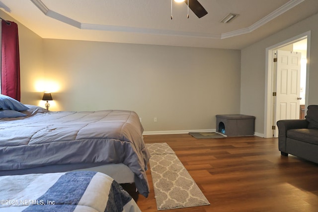 3038 Majestic Oaks Ln, Green Cove Springs, FL 32043 - bedroom with baseboards, ornamental molding, visible vents, a tray ceiling, and wood finished floors