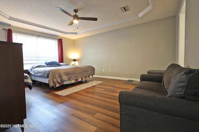 3038 Majestic Oaks Ln, Green Cove Springs, FL 32043 - bedroom featuring dark wood-style flooring, a textured ceiling, crown molding, visible vents, and a raised ceiling