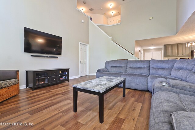3038 Majestic Oaks Ln, Green Cove Springs, FL 32043 - living area featuring baseboards, stairway, a towering ceiling, and wood finished floors