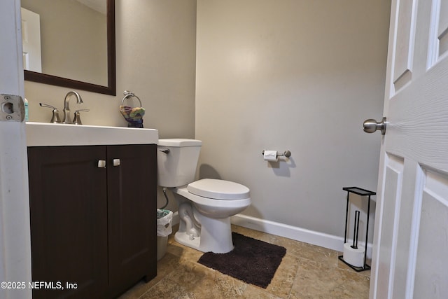 3038 Majestic Oaks Ln, Green Cove Springs, FL 32043 - half bathroom with toilet, stone finish floor, vanity, and baseboards