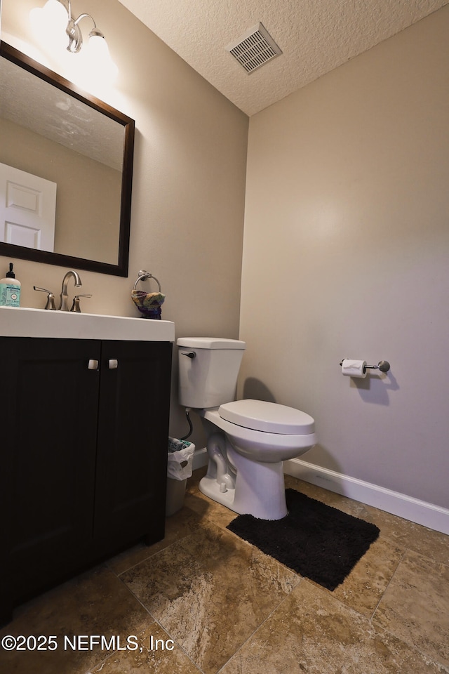 3038 Majestic Oaks Ln, Green Cove Springs, FL 32043 - bathroom featuring visible vents, baseboards, toilet, a textured ceiling, and vanity