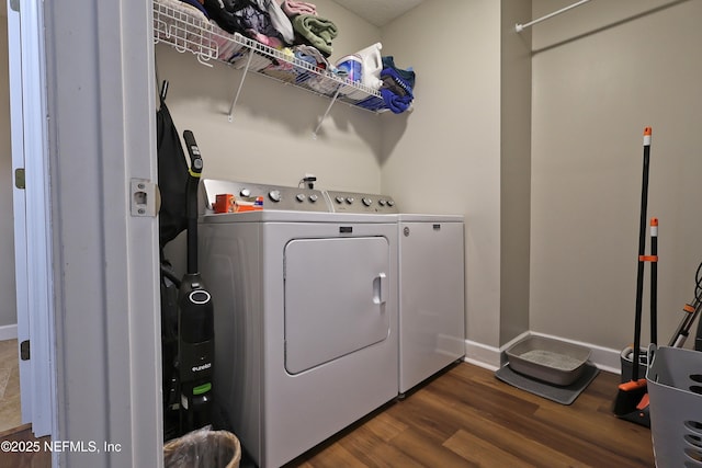 3038 Majestic Oaks Ln, Green Cove Springs, FL 32043 - laundry area with dark wood-type flooring, washing machine and dryer, laundry area, and baseboards