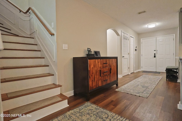 3038 Majestic Oaks Ln, Green Cove Springs, FL 32043 - foyer entrance with stairs, dark wood-style flooring, and baseboards