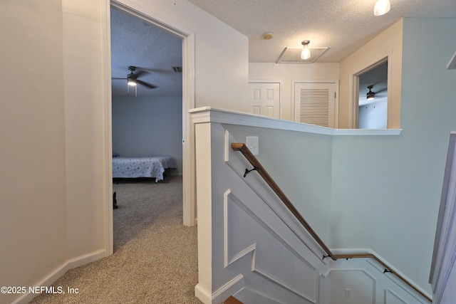 3038 Majestic Oaks Ln, Green Cove Springs, FL 32043 - stairway with a textured ceiling, ceiling fan, and carpet