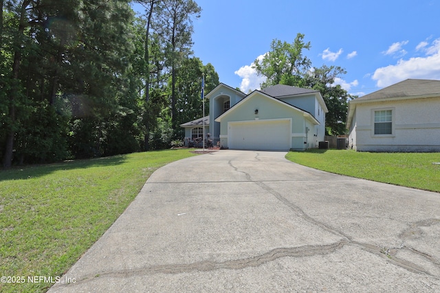 3038 Majestic Oaks Ln, Green Cove Springs, FL 32043 - view of front of house featuring an attached garage, driveway, central AC unit, and a front lawn