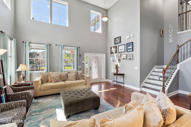 11725 Paddock Gates Dr, Jacksonville, FL 32223 - living area featuring a high ceiling, stairs, wood finished floors, baseboards, and plenty of natural light