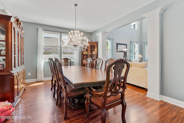 11725 Paddock Gates Dr, Jacksonville, FL 32223 - dining room with healthy amount of natural light, a chandelier, hardwood / wood-style floors, and a textured ceiling
