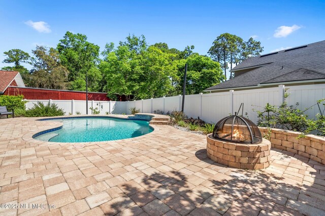 11725 Paddock Gates Dr, Jacksonville, FL 32223 - view of pool featuring a fire pit, a patio area, and a fenced backyard