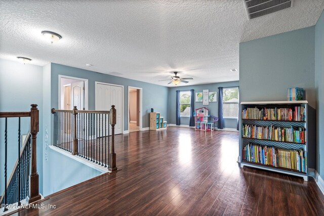 11725 Paddock Gates Dr, Jacksonville, FL 32223 - empty room with wood finished floors, ceiling fan, a textured ceiling, and baseboards