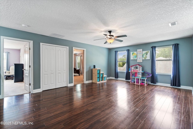 11725 Paddock Gates Dr, Jacksonville, FL 32223 - bedroom featuring wood finished floors, a textured ceiling, a closet, ceiling fan, and baseboards